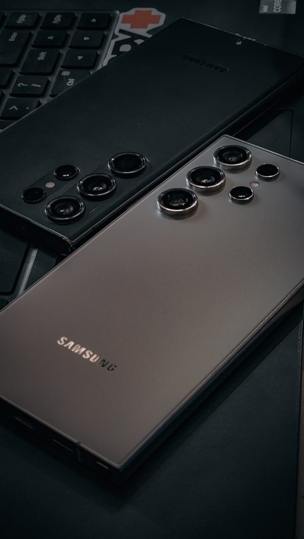 a close up of a cell phone near a keyboard