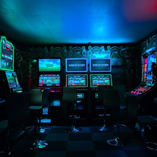 Photo by Carl Raw gaming room with arcade machines
